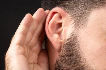 closeup man ear with palm listening collecting rumors concept secret sense organs hearing-hno21